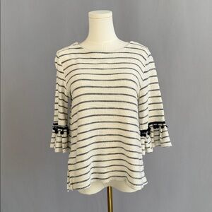 Chic, coastal, & effortlessly stylish ruffle-sleeve blend of classic & feminine.